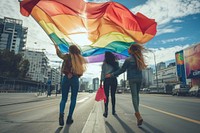 Couple lesbian woman with gay pride flag on the street adult city transportation.