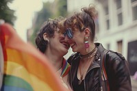Happy couple lesbian woman with gay pride flag on the street photography portrait jewelry.