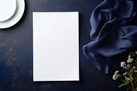 Paper white blank menu card on white plate blue elegance absence.