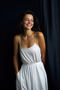 A happy woman in a clean white dress laughing portrait smile.