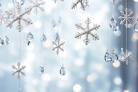Elegant snowflakes suspended from a luminous bright light white background backgrounds christmas symbol.