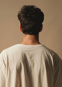 A man wear cream oversize t shirt adult back contemplation.