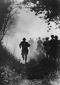 Man running surrounded by people outdoors walking nature.