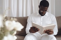 Black man reading book and show empty white cover book up in front view publication sitting adult.