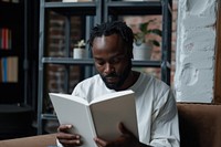 Black man reading empty white book and show cover book up in front view publication adult contemplation.