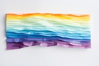 Torn strip of rainbow paper art white background creativity.