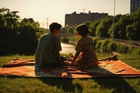 Couple sitdown on fabric outdoors blanket summer.