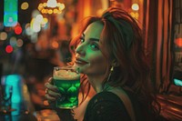 Irish woman drinking green beer adult bar illuminated.