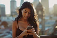 Young latin female photography texting adult.