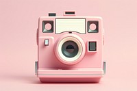 Pink polaroid camera photographing electronics technology.