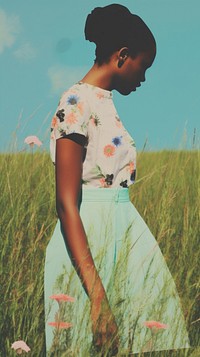 Black woman in the meadow dress skirt grass.