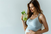 Healthy pregnant woman drink drinking mojito.