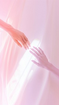 Two hand holding pink abstract clothing.