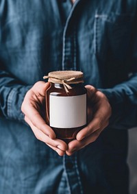 Man holding a jar of jam midsection container lighting.