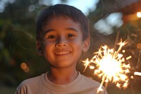 Boy holding sparkler portrait sparks child.