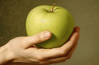 Hand and green apple painting fruit plant.