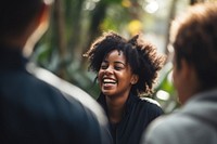 Black female interacting with friends laughing adult togetherness.