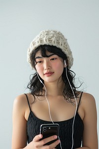 Women using using smart phone and Earbuds portrait adult hat.