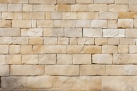 Yellowish french limestone wall architecture texture.