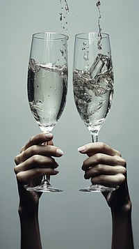 Grey tone hands cheers champagne glasses drink refreshment celebration.