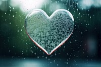 Heart icon drawn on misted window transparent raindrop.