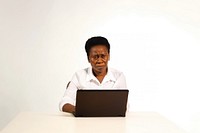 Africa middle-age woman type laptop computer portrait sitting.