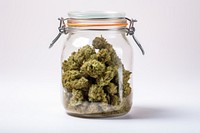Cannabis in a glass jar cannabis plant white background.