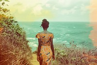 African woman walking on walkpath by sea adult back contemplation.