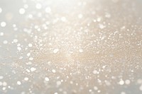 Pale glitter cream texture backgrounds defocused snowflake.