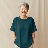 Old Asian woman in teal oversized t-shirt