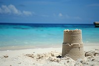 Building a sandcastle on the beach outdoors nature ocean.