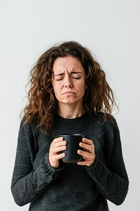 A Tired sleepy woman cup worried sweater.