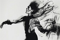 Dances with a human skeleton adult woman representation.