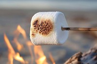 Roasting marshmallow fire corrosion outdoors.