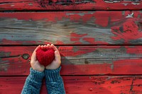 Child hands holding red heart relaxation outdoors symbol.