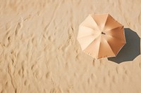 Beach umbrella on sand backgrounds outdoors nature.