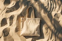 Tote bag on sand backgrounds outdoors handbag.