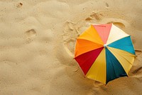 Beach umbrella on sand backgrounds outdoors summer.