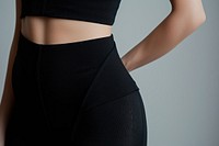 Woman waist wearing black bodysuit adult gray undergarment.