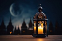 Ornamental Arabic lantern candle lighting outdoors.