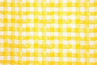 Yellow gingham plaid fabric backgrounds tablecloth repetition.