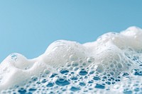 Textured foam on blue background backgrounds splashing freezing.