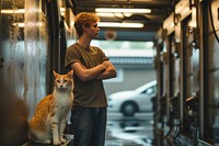 Young man standing with arms crossed at car wash tunnel pet photography portrait.