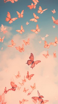 Butterflies flying through a cloudy sky petal plant pink.