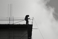 Engineer worker working building architecture silhouette.