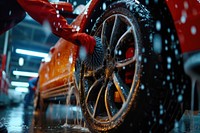 Employee of a car wash vehicle wheel tire.