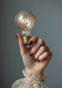 Woman holding light bulb hand lightbulb finger.