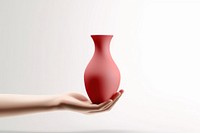 Hand holding a vase pottery white background simplicity.