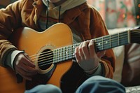 Boy was teached to play guitar musician performance midsection.