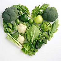 Variety of green vegetables forming heart-shape cauliflower broccoli plant.